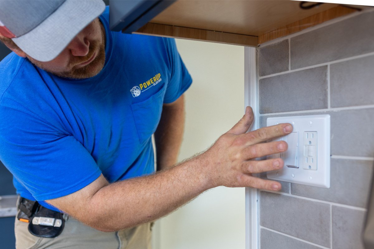 PowerUp Electric - wokring on a replaced outlet & switch in the Eastern Iowa Area, as part of their electrical outlet repair & installation services